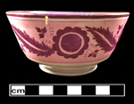Bone china London-shaped bowl with pink and purple luster painted floral decoration.